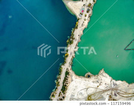 sandy shore with colourful water 117159496