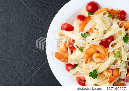 Italian pasta with shrimps , parmesan and tomatoes 117160257