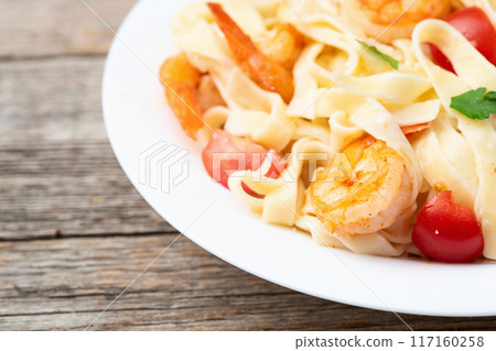 Italian pasta with shrimps , parmesan and tomatoes Italian pasta with shrimps , parmesan and tomatoes 117160258