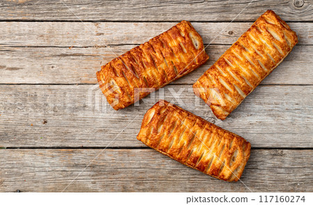 Golden Puff pastry stuffed with sausage and cheese 117160274