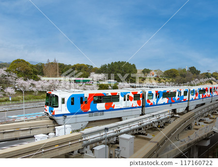 A monorail wrapped in the design of Myakumyaku, the official mascot of the Osaka-Kansai Expo, and cherry blossoms in full bloom 117160722