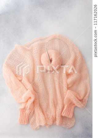 Home hobby, knitting a spider web sweater from pink threads Home hobby, knitting a spider web sweater from pink threads 117162026
