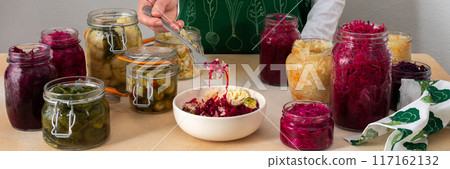 Woman fermenting fresh vegetables 117162132