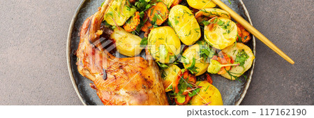Baked rabbit with potatoes and carrots, a set table with food Baked rabbit with potatoes and carrots, a set table with food 117162190