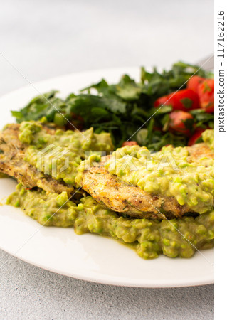 Enjoy a healthy breakfast with zucchini pancakes topped with green pea pesto, served with a mixed salad of fresh seasonal vegetables and herbs Enjoy a healthy breakfast with zucchini pancakes topped with green pea pesto, served with a mixed salad of fresh seasonal vegetables and herbs 117162216