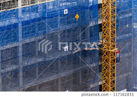 New construction site with crane and mechanical equipments New construction site with crane and mechanical equipments 117162833