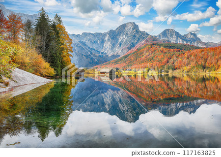 Breathtaking autumn scene of sunny morning on Almsee lake. Breathtaking autumn scene of sunny morning on Almsee lake. 117163825