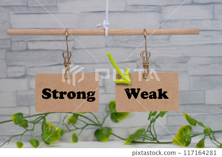 Weak hanging on the scales with an arrow and Strong 117164281