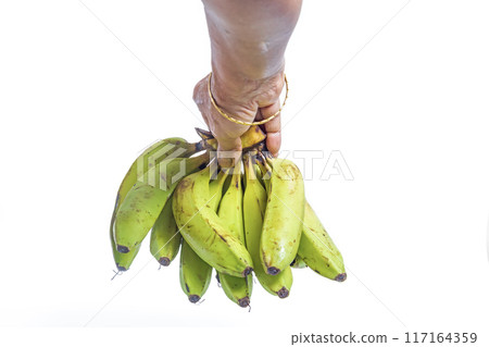 Indian woman wearing gold bangle holding bunch of bananas on white background. Closeup 117164359