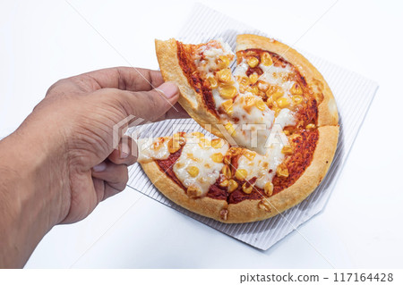 Human hand taking piece of delicious corn and cheese pizza isolated on white background. Human hand taking piece of delicious corn and cheese pizza isolated on white background. 117164428