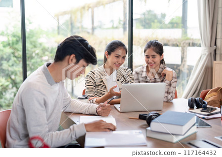 Group of Student Collaboration on a Project in a Modern Study Space with Laptops and Books Group of Student Collaboration on a Project in a Modern Study Space with Laptops and Books 117164432