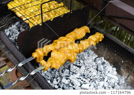 Juicy Chicken Satay on Charcoal Grill Outdoor Cooking 117164796