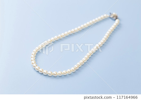 Pearl necklace on a blue background 117164966