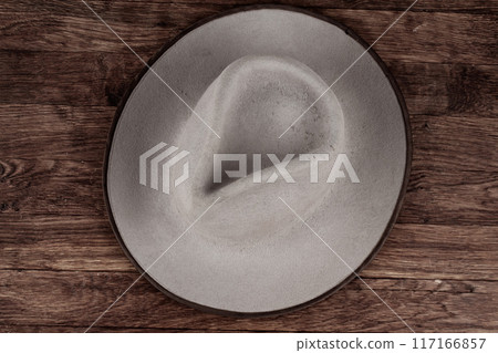 Old west cowboy hat on table. Old west cowboy hat on table. 117166857