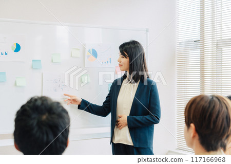 A woman giving a presentation A woman giving a presentation 117166968