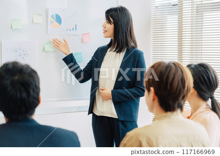 A woman giving a presentation A woman giving a presentation 117166969
