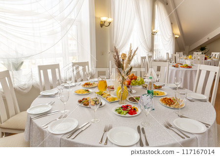 Wedding banquet in restaurant, covered round table for guests 117167014