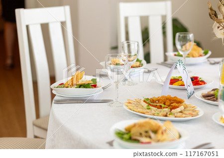 Wedding banquet in restaurant, covered round table for guests Wedding banquet in restaurant, covered round table for guests 117167051