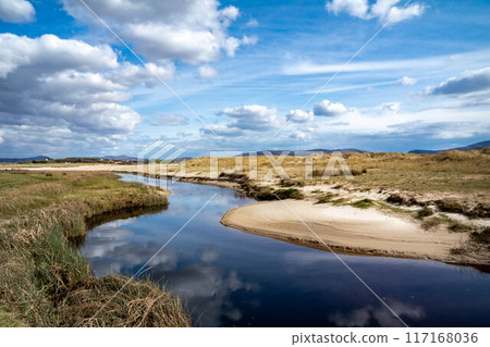 The stream that flows from Sheskinmore Nature Reserve to Ballinravey Strand between Ardara and Portnoo in Donegal - Ireland 117168036