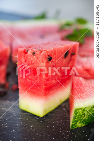 pieces of ripe red watermelon, close-up, on a board 117168045