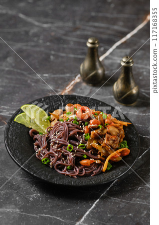 Black rice noodles with fried prawns and shrimps Black rice noodles with fried prawns and shrimps 117168355