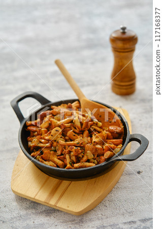 Fried chanterelles in cast iron skillet 117168377