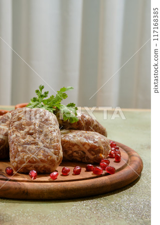 Close-up view of traditional Georgian raw beef cutlets - Apkhazura, wrapped in fat net Close-up view of traditional Georgian raw beef cutlets - Apkhazura, wrapped in fat net 117168385