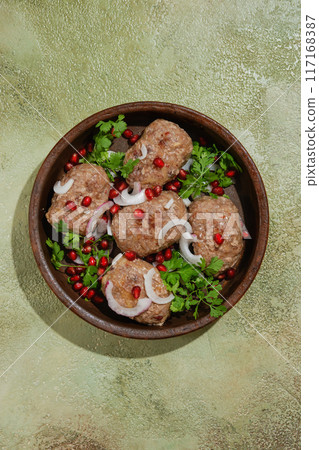Overhead view of traditional Georgian fried meal Apkhazura in clay pot Overhead view of traditional Georgian fried meal Apkhazura in clay pot 117168387