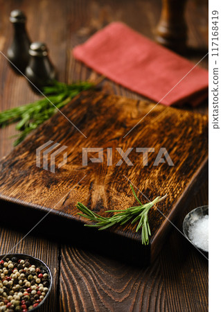 Empty wooden chopping board on kitchen table Empty wooden chopping board on kitchen table 117168419