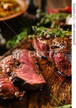 Close-up overhead view of grilled top blade beef steak cut on slices 117168428