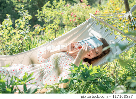 Young woman relaxing in a hammock Young woman relaxing in a hammock 117168587