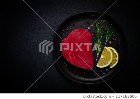 fresh red tuna fillet, for steak, raw, top view, on a black plate , no people, fresh red tuna fillet, for steak, raw, top view, on a black plate , no people, 117168606