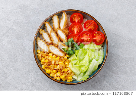 Crispy breaded chicken poke bowl on a gray background for a food delivery site Crispy breaded chicken poke bowl on a gray background for a food delivery site 117168867