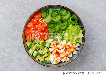 Hawaiian salmon poke bowl with avocado, Top view, gray background 117169243