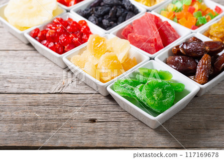 Group of dried and candied fruit in bowl 117169678