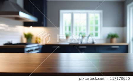 Blurred modern kitchen with wooden countertop, natural light from window. 117170630