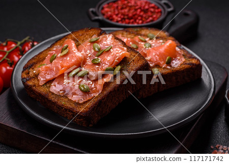 Sandwich or bruschetta with toast, salmon, cream cheese 117171742