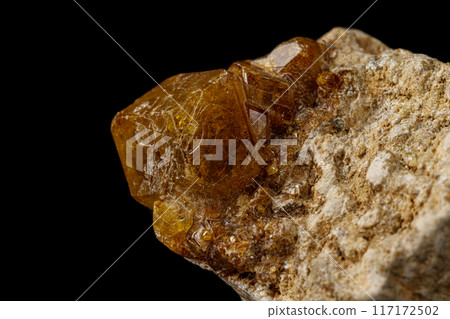 Macro stone Grossular mineral on a black background 117172502