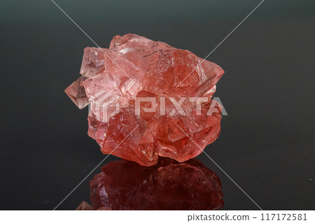 macro mineral stone pink fluorite on a black background 117172581