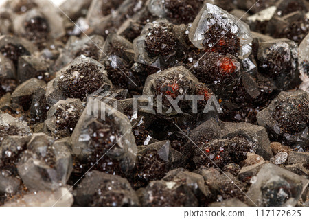 Macro of a stone Ilvaite mineral on a white background Macro of a stone Ilvaite mineral on a white background 117172625