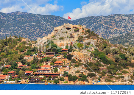 View of ancient Lycian town Simena with fortress on a mount on the coast of the Mediterranean sea in Antalya Province, Turkey View of ancient Lycian town Simena with fortress on a mount on the coast of the Mediterranean sea in Antalya Province, Turkey 117172984