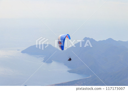 Paragliders flying from a top of Tahtali mountain near Kemer, Antalya Province in Turkey. Concept of active lifestyle and extreme sport adventure Paragliders flying from a top of Tahtali mountain near Kemer, Antalya Province in Turkey. Concept of active lifestyle and extreme sport adventure 117173007