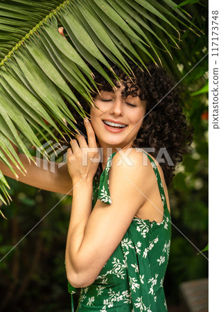 Exotic female model among green leaves Exotic female model among green leaves 117173748