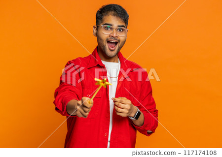 Magician wizard young man gesturing with magic wand making wish come true, casting magician spell 117174108