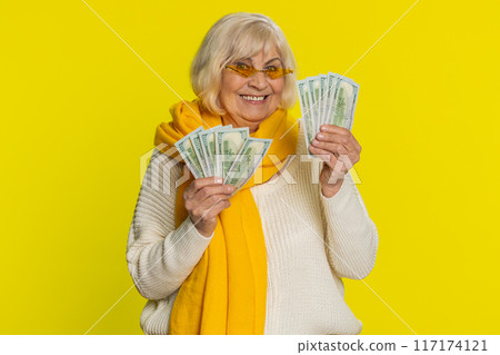 Senior old winner woman holding fan of cash money dollar banknotes celebrate dance, success pension Senior old winner woman holding fan of cash money dollar banknotes celebrate dance, success pension 117174121