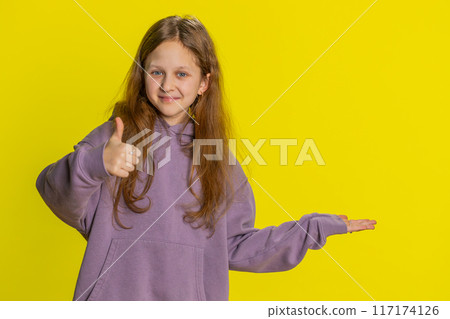 Child girl kid showing thumbs up and pointing on blank space place for advertisement promotion logo Child girl kid showing thumbs up and pointing on blank space place for advertisement promotion logo 117174126