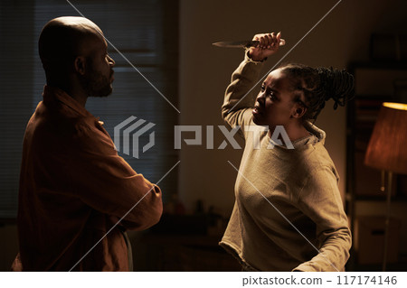 Frantic woman threatening her husband 117174146