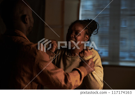 Woman with clenched fists and teeth 117174163
