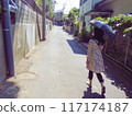 A woman walking with a sunshade 117174187