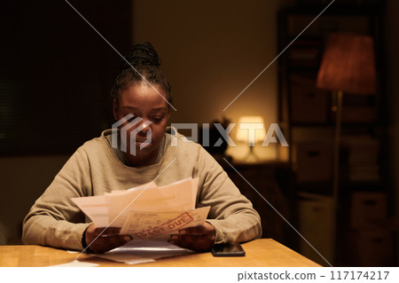 Young upset woman with past due bills Young upset woman with past due bills 117174217